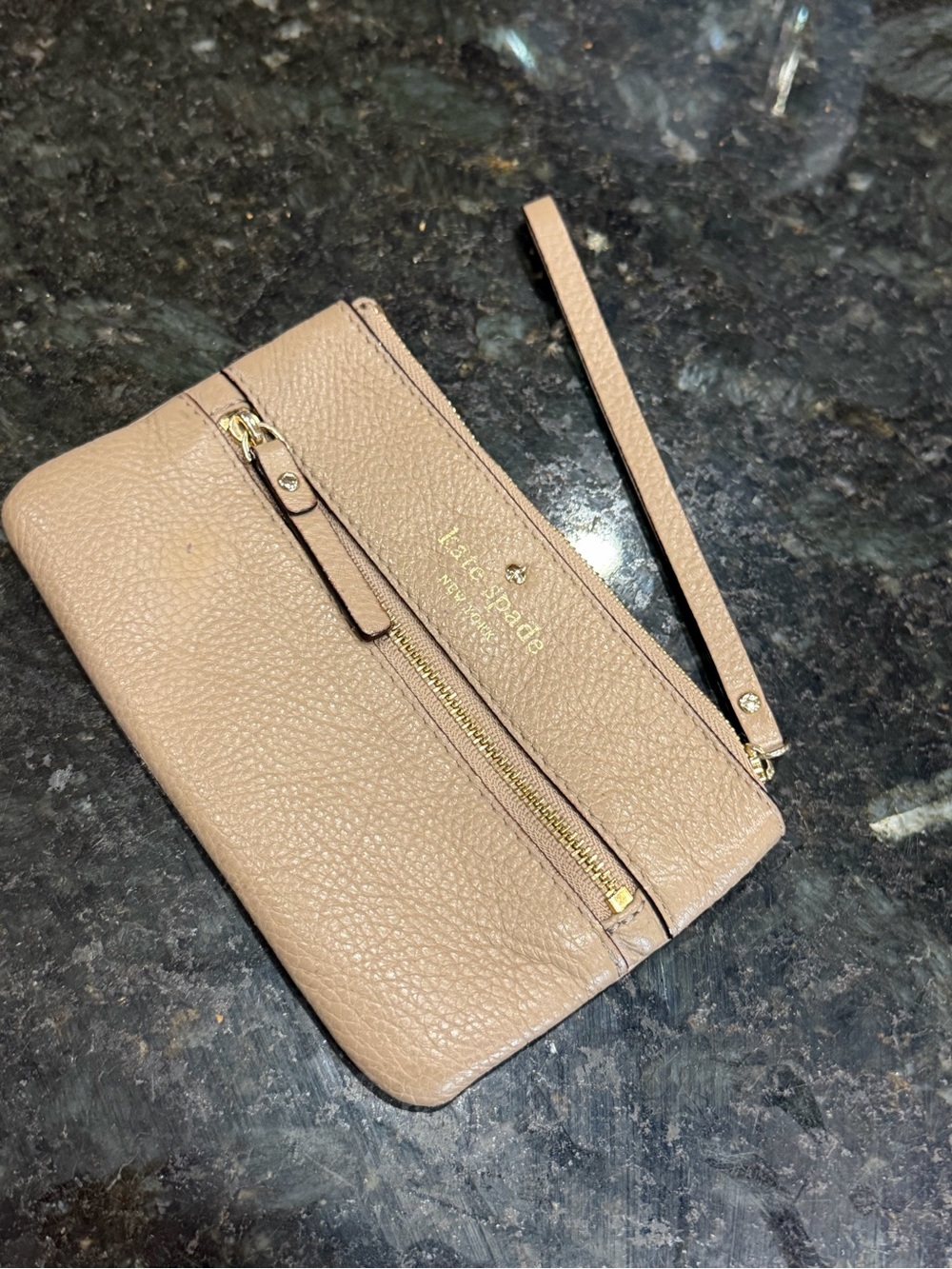 Kate Spade Beige Pebbled Leather Wristlet with Front zipper pocket.